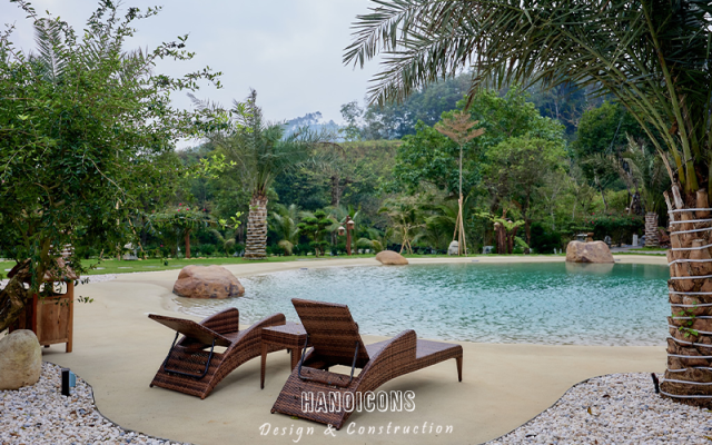 Ghế thư giãn bên hồ bơi vô cực nước mặn trong khuôn viên sân vườn biệt thự nghỉ dưỡng.